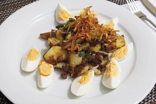Close up of hard boiled eggs with roasted potatoes and onions  CSF015124