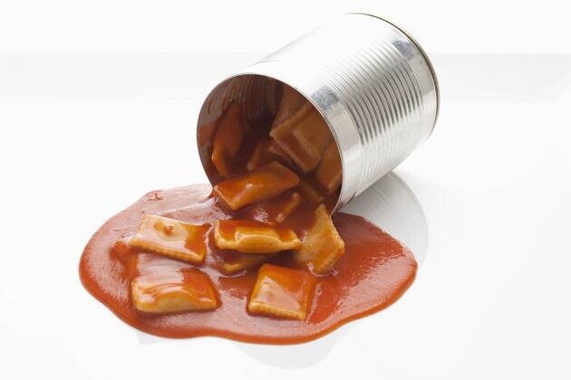 Filled ravioli pouring out of tin on white background  CSF018025