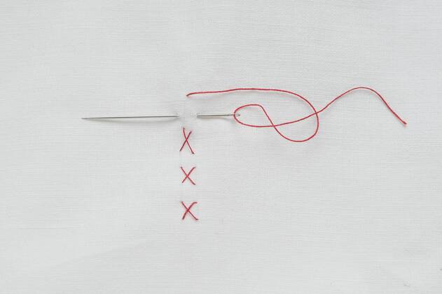 Embroidery cross on fabric with red thread  CRF002390