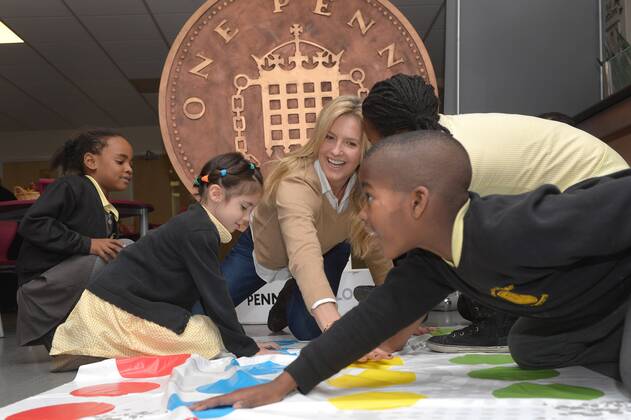 . 18 12 2014. London, United Kingdom. Penny Lancaster visits Charlton Manor Primary School where the Mayors Fund initiative Penny for London is raising money to fund breakfasts for school children. Penny Lancaster plays Twister with children at breakfast club.  xBenxStevensx xi-Imagesx IIM-3778-0004