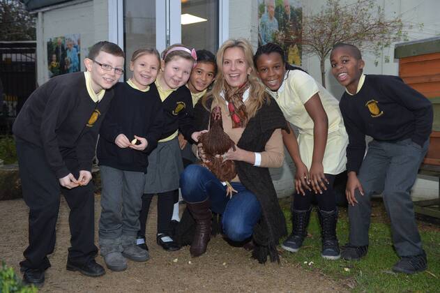 . 18 12 2014. London, United Kingdom. Penny Lancaster visits Charlton Manor Primary School where the Mayors Fund initiative Penny for London is raising money to fund breakfasts for school children. Penny Lancaster visits the school s chickens during breakfast club with students at Charlton Manor Primary School  xBenxStevensx xi-Imagesx IIM-3778-0005