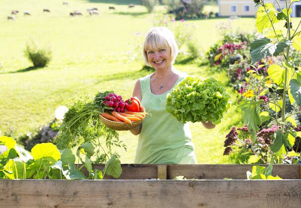 Austria, Mondsee, portrait of happy woman with her vegetable harvest model released Symbolfoto property released  WWF003629