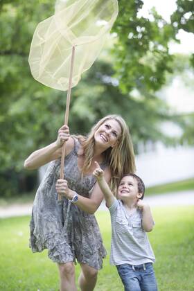 Mother and son catching butterflies with a net model released Symbolfoto property released  ZEF003485