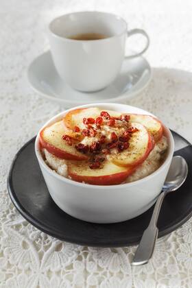Bowl of porridge with roasted apple and cup of coffee  EVGF001399