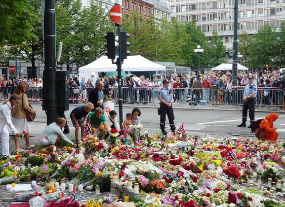 OSLO, Norway - People offer flowers near a cathedral in Oslo, Norway, on July 24, 2011. The cathedral held a mass the same day to mourn the dozens of victims of attacks by a man in Oslo and the island of Utoya on July 22.  0725007