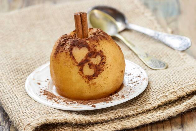 Baked apple decorated with cinnamon heart shape ornament  Copyright: KantarukxAgnieszka bew17B6EDF