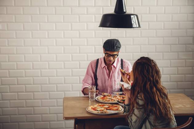 Young couple eating pizza in restaurant model released Symbolfoto property released CHAF001284