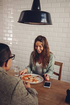 Young couple eating pizza in restaurant model released Symbolfoto property released CHAF001291