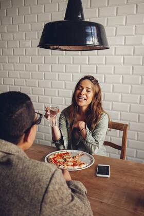 Young couple eating pizza in restaurant model released Symbolfoto property released CHAF001292