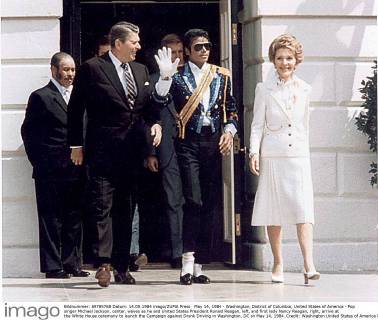 May 14, 1984 - Washington, District of Columbia, United States of America - Pop singer Michael Jackson, center, waves as he and United States President Ronald Reagan, left, and first lady Nancy Reagan, right, arrive at the White House ceremony to launch the Campaign against Drunk Driving in Washington, DC on May 14, 1984..Credit: Washington United States of America - ZUMAs152
