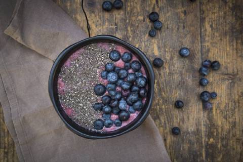 Blueberry smoothie with chia seeds in bowl, fresh blueberries  LVF004501
