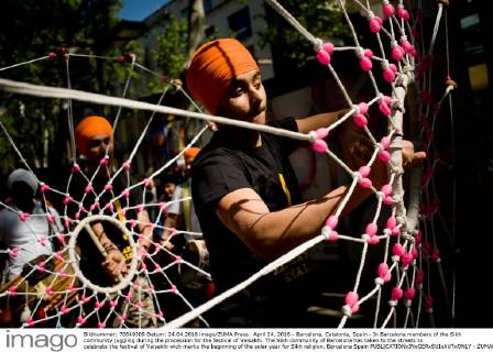 April 24, 2016 - Barcelona, Catalonia, Spain - In Barcelona members of the Sikh community juggling during the procession for the festival of Vaisakhi. The Sikh community of Barcelona has taken to the streets to celebrate the festival of Vaisakhi wich marks the beginning of the solar year for Sikh religion. Barcelona Spain - ZUMAb137
