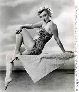 IMAGO ICONS: Marilyn Monroe American actress Marilyn Monroe posing sitting on the trampoline in a swimsuit 02738 