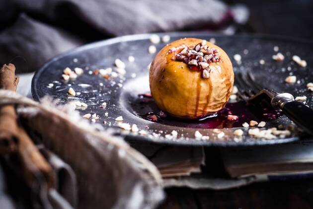 Baked apple with nut- and red jam filling on tin plate  SBDF002954