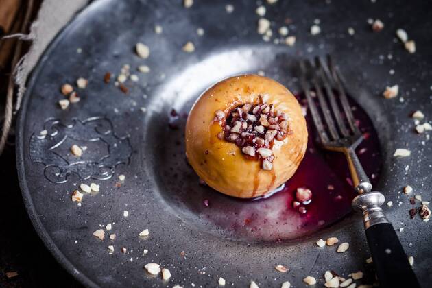 Baked apple with nut- and red jam filling on tin plate  SBDF002955
