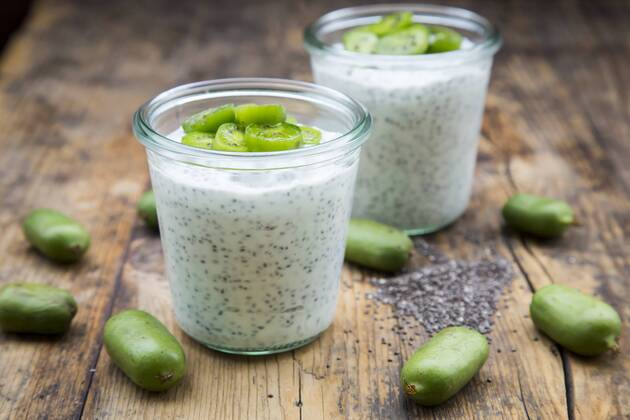Two glasses of natural yoghurt with chia seeds and slices of hardy kiwis  LVF05465
