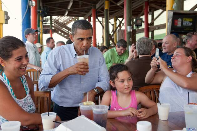 Jul. 21, 2010 - Fort Morgan, AL - President Barack Obama sips an iced tea while talking to patrons at Tacky Jack s, a seafood restaurant in Orange Beach, Ala., during his tour of the Gulf Coast, June 14, 2010. This was the President s fourth trip to the Gulf Coast to assess the ongoing response to the BP oil spill in the Gulf of Mexico. Barack Hussein Obama II (born August 4, 1961) is the 44th President of the United States. He is the first African American to be elected to office and the first president born outside the contiguous United States. Born in Honolulu, Hawaii, Obama is a graduate of Columbia University and Harvard Law School. He worked as a civil rights attorney and taught constitutional law at the University of Chicago Law School from 1992 to 2004. While serving three terms representing the 13th District in the Illinois Senate from 1997 to 2004, he ran unsuccessfully in the - ZUMAz03_ 20100721_shh_z03_840