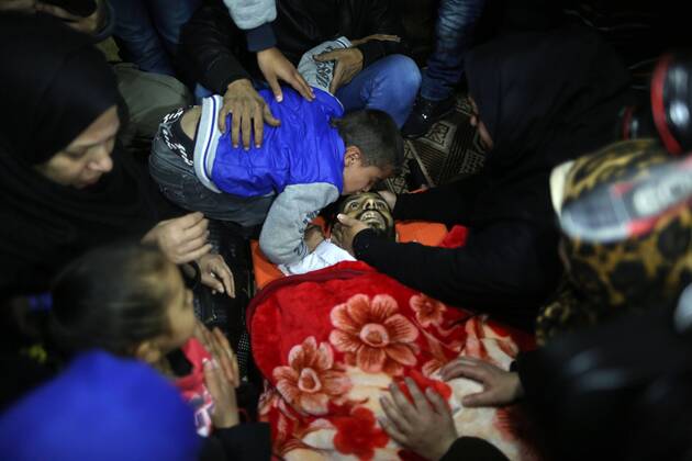 February 9, 2017 - Gaza City, Gaza Strip, Palestinian Territory - Relatives look at the body of Palestinian Mohammed al-Aqraa, who was killed in a tunnel explosion near the Egyptian border, during his funeral. Gaza Palestine - ZUMAn230 20170209_zaa_n230_058 Copyright: xMajdixFathix