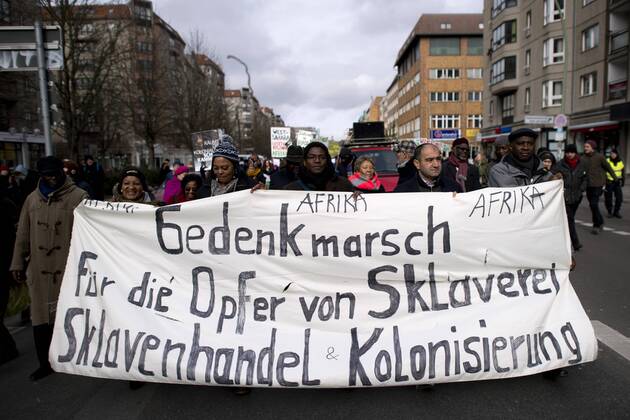 Bilder des Tages Gedenkmarsch Kolonialgeschichte DEU, Deutschland, Germany, Berlin, 25.02.2017 Demonstranten mit Transparent beim 11. Gedenkmarsch zur Erinnerung an die afrikanischen Opfer von Versklavung, Kolonialismus und rassistischer Gewalt vom Komitee fuer ein afrikanisches Denkmal in Berlin und afrikanischer Vereine in Berlin. Dieser Gedenkmarsch wurde ins Leben gerufen, um der Forderung nach Anerkennung der Verbrechen gegen Schwarze Menschen und Menschen afrikanischer Herkunft Nachdruck zu verleihen. Anlass ist die Berliner Afrika-Konferenz von 1884 - 1885, auf der Afrika vor 130 Jahren unter den europaeischen Kolonialmaechten aufgeteilt wurde. Mehr als 30 Millionen Afrikanerinnen und Afrikaner wurden Opfer von Versklavung und kolonialen Verbrechen gegen die Menschlichkeit. Die von Deutschland an den Herero und Nama begangenen Voelkermorde in Namibia und die Kriegsverbrechen in Tansania im Maji- M