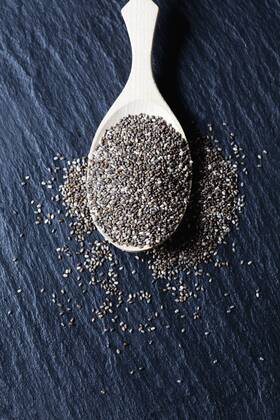 Wooden spoon of black chia seeds on slate  CSF28016