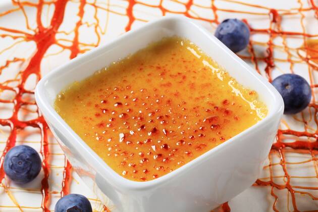 Creme brulee garnished with caramelized sugar decoration and blueberries CTKPhotoF201704110895701 