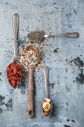 Spoons of black chia seeds, wolfsberries, nuts and quinoa  MYF01903