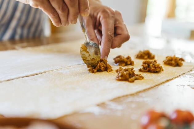 Woman s hands putting ravioli stuffing on dough model released Symbolfoto property released  JRFF01402