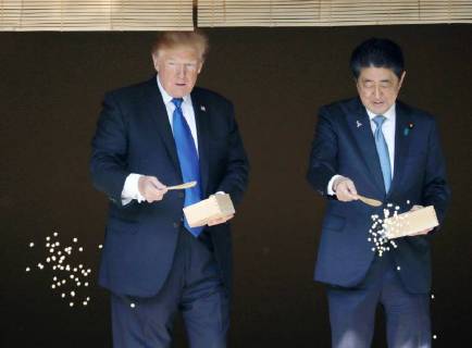 Trump in Japan Japanese Prime Minister Shinzo Abe (R) and U.S. President Donald Trump feed carp in a pond at the Akasaka Palace state guesthouse in Tokyo on Nov. 6, 2017. Trump was in Japan for a three-day visit, part of his first trip to Asia since his inauguration. (Pool photo)