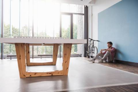 Man sitting on the floor in break room of modern office model released Symbolfoto property released  DIGF02759