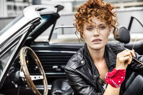 Portrait of confident redheaded woman in sports car model released Symbolfoto FMKF04497
