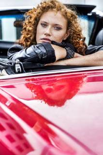 Portrait of confident redheaded woman in sports car model released Symbolfoto FMKF04519