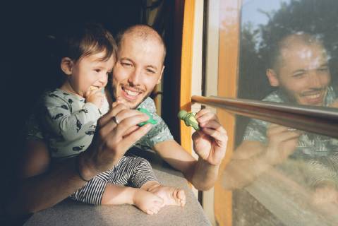 Father playing with his baby girl while traveling by train model released Symbolfoto  GEMF01814