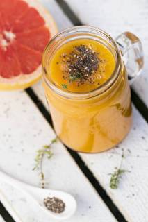 Glass of fruit smoothie with Pink Grapefruit, orange, mango, thyme and chia seeds  YFF00679