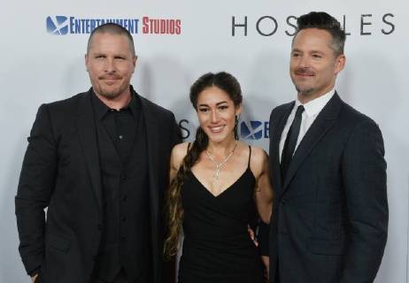 Cast members Christian Bale and Q orianka Kilcher join director Scott Cooper (R) on the red carpet during the premiere of the motion picture western Hostiles at the Academy of Motion Picture Arts & Sciences in Beverly Hills, California on December 14, 2017. Storyline: In 1892, a legendary Army captain reluctantly agrees to escort a Cheyenne chief and his family through dangerous territory.  LAP2017121406 JIMxRUYMEN