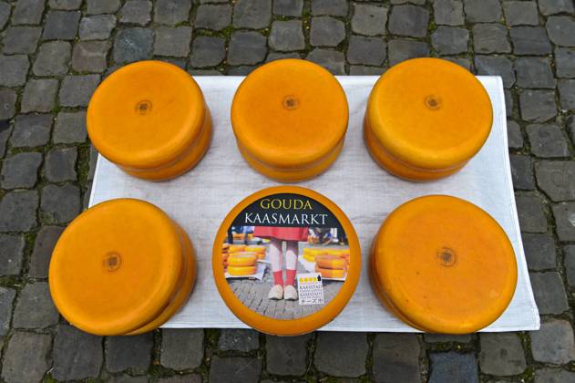 Gouda cheese wheels piled up on the cheese market, Gouda, Netherlands