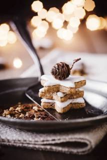 Stack of three cinnamon stars on plate  HESF00001