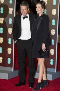 February 18, 2018 - London, London, UK - Hugh Grant and Anna Eberstein arrives on the red carpet for the EE British Academy Film Awards 2018, held at the Royal Albert Hall. London UK  - ZUMAt138 20180218_zap_t138_052 Copyright: xRayxTangx