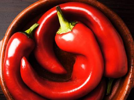 3. bent bell peppers in a bowl 3 crooked peppers bell peppers in a bowl on dark background  1028900630