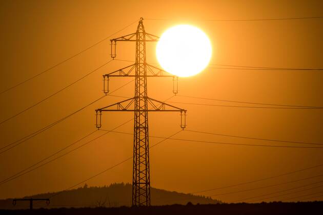Sunset behind power pole 22 02 2018 Kronberg The sun goes behind the mast of a high voltage power line under Kronberg Germany