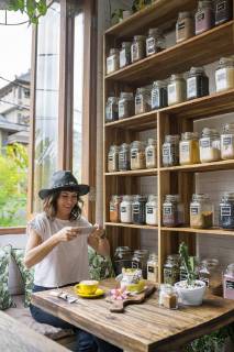 Woman with hat in a cafe taking picture of food with smartphone model released Symbolfoto property released  SBOF01180
