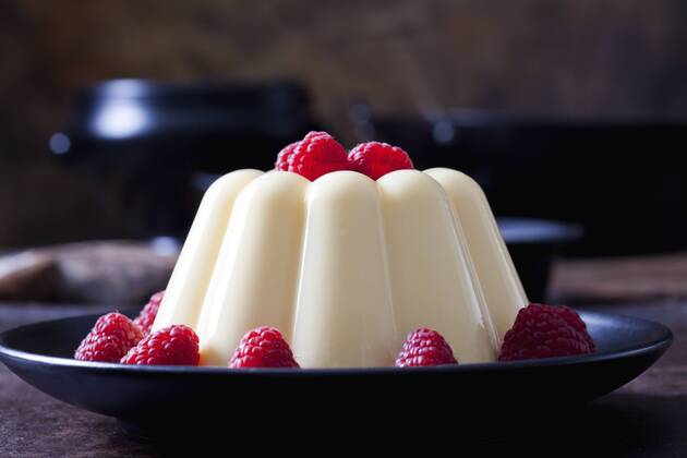 Custard with raspberries on plate  CSF28729