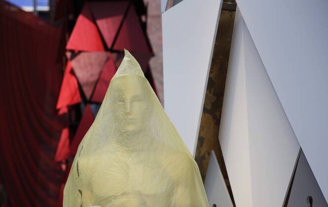 An Oscar statue is wrapped in plastic on the red carpet as preparations continue for the 90th annual Academy Awards in the Hollywood section of Los Angeles on March 3, 2018. Oscar winners will be announced during an ABC telecast on Sunday, March 4th at the Dolby Theatre.  LAP20180303903 JOHNxANGELILLO