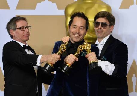 (L-R) Set decorator Jeffrey A. Melvin, production designer Paul Denham Austerberry, and set decorator Shane Vieau, winners of the Best Production Design award for The Shape of Water, appear backstage with his Oscar during the 90th annual Academy Awards at Loews Hollywood Hotel in the Hollywood section of Los Angeles on March 4, 2018.  LAP20180304992 JIMxRUYMEN