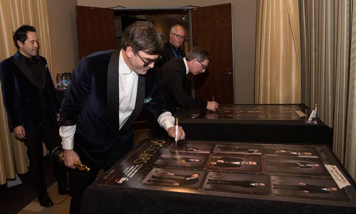 Paul Denham Austerberry (left), Shane Vieau (center), and Jeffrey A. Melvin (right) sign posters backstage after accepting the Oscar for achievement in production design for work on The Shape of Water during the live ABC Telecast of The 90th OscarsÂ® at the DolbyÂ® Theatre in Hollywood, CA on Sunday, March 4, 2018.  Copyright: xRobertxGladdenx 33546_543PLX