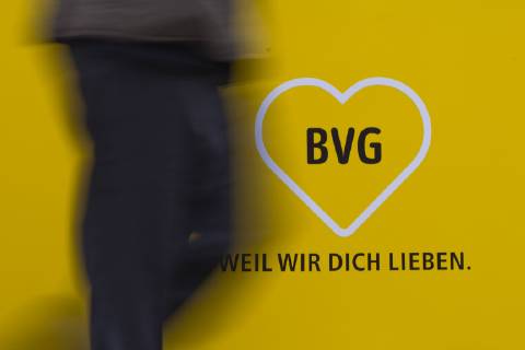A person is passing a logo of the BVG Berliner Verkehrsgesellschaft in Berlin 26 03 2018 Berlin Germany Copyright: xFlorianxGaertner photothek.netx