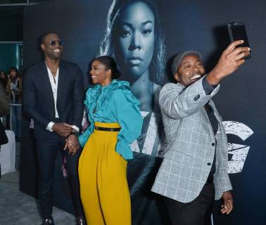 Cast member Gabrielle Union and her husband, NBA player Dwayne Wade react as producer Will Packer does a selfie during the special screening of the motion picture thriller Breaking In at the ArcLight Cinema Dome in the Hollywood section of Los Angeles on May 1, 2018. Storyline: A woman fights to protect her family during a home invasion.  LAP2018050112 JIMxRUYMEN