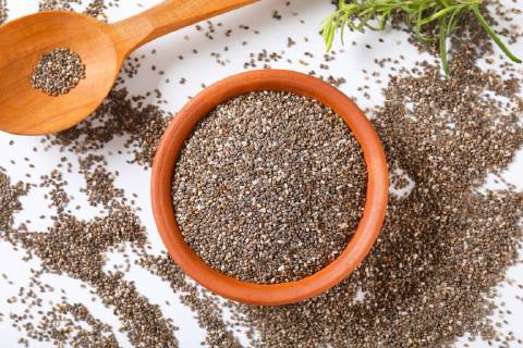 bowl of healthy chia seeds and wooden spoon on white background CTKPhotoF201805161195601 