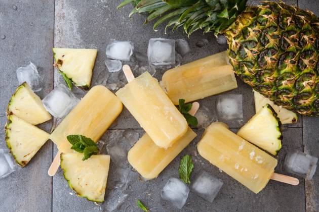 Homemade popsicles with fresh pineapple. Frozen pineapple popsicles  1079704926