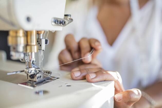 Close-up of woman using sewing machine model released Symbolfoto property released  ZEF15320