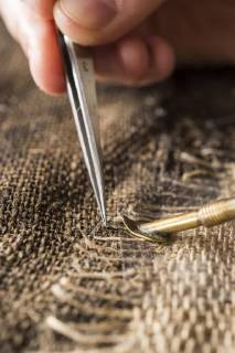 Restaurationsatelier Restauratorin Fix with putty and tweezers patches with thread bridge over crack in fast cloth Munich Bavaria Germany Europe Copyright: imageBROKER/JohannesxGeyer ibljog04672242.jpg
